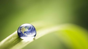 Earth in a water drop on top of a leave